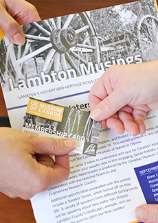Person handing someone a membership card.