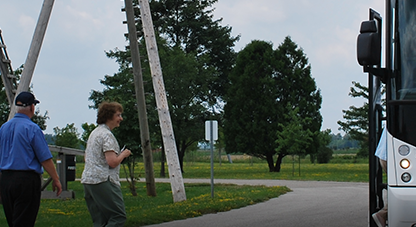 Two people walking towards a bus 